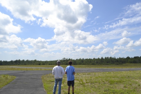 David flying an RC plane on a buddy box 